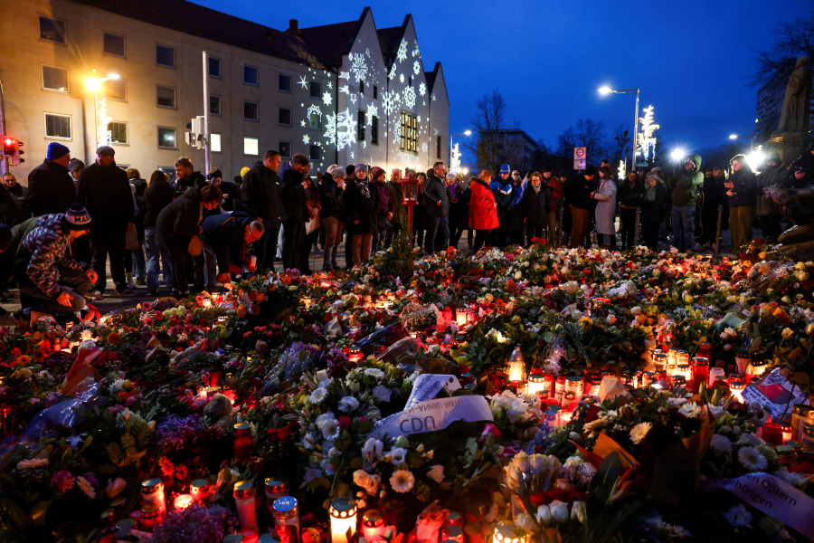 Suspect in German Christmas market attack held on murder charges after night of grief, scuffles