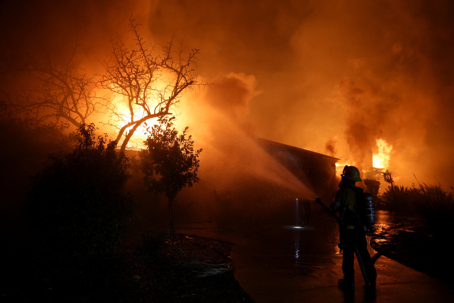 Tens of thousands flee as wildfires tear through Los Angeles area