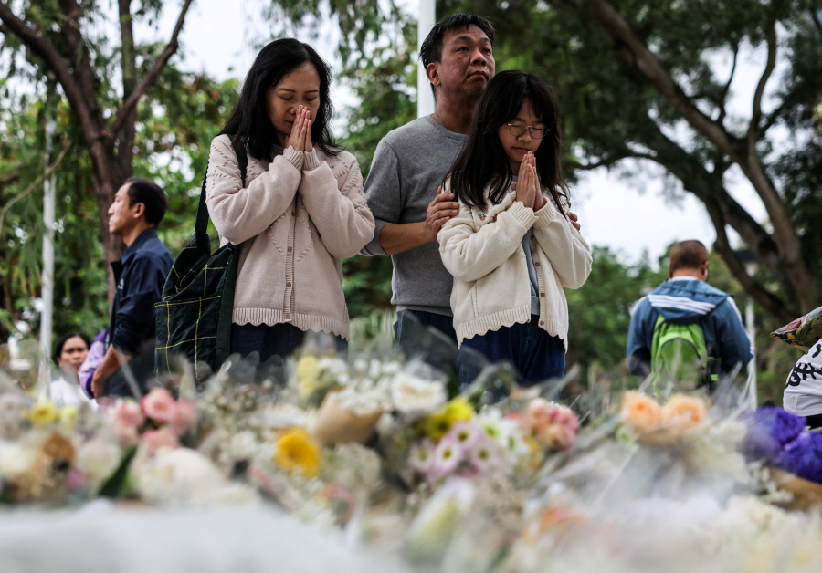 Mourners flock to site of deadly Hong Kong blaze as Beijing warns against protests