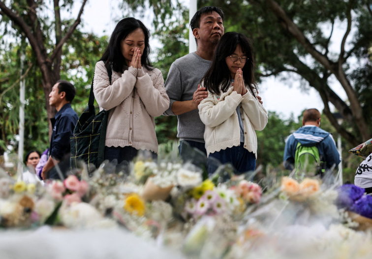 Mourners flock to site of deadly Hong Kong blaze as Beijing warns against protests