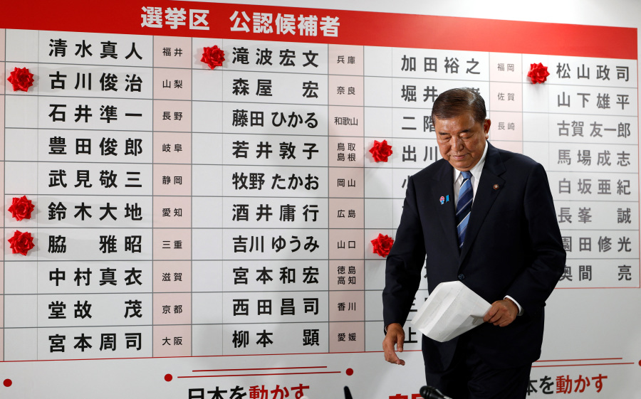 Japan PM vows to stay on after bruising election defeat